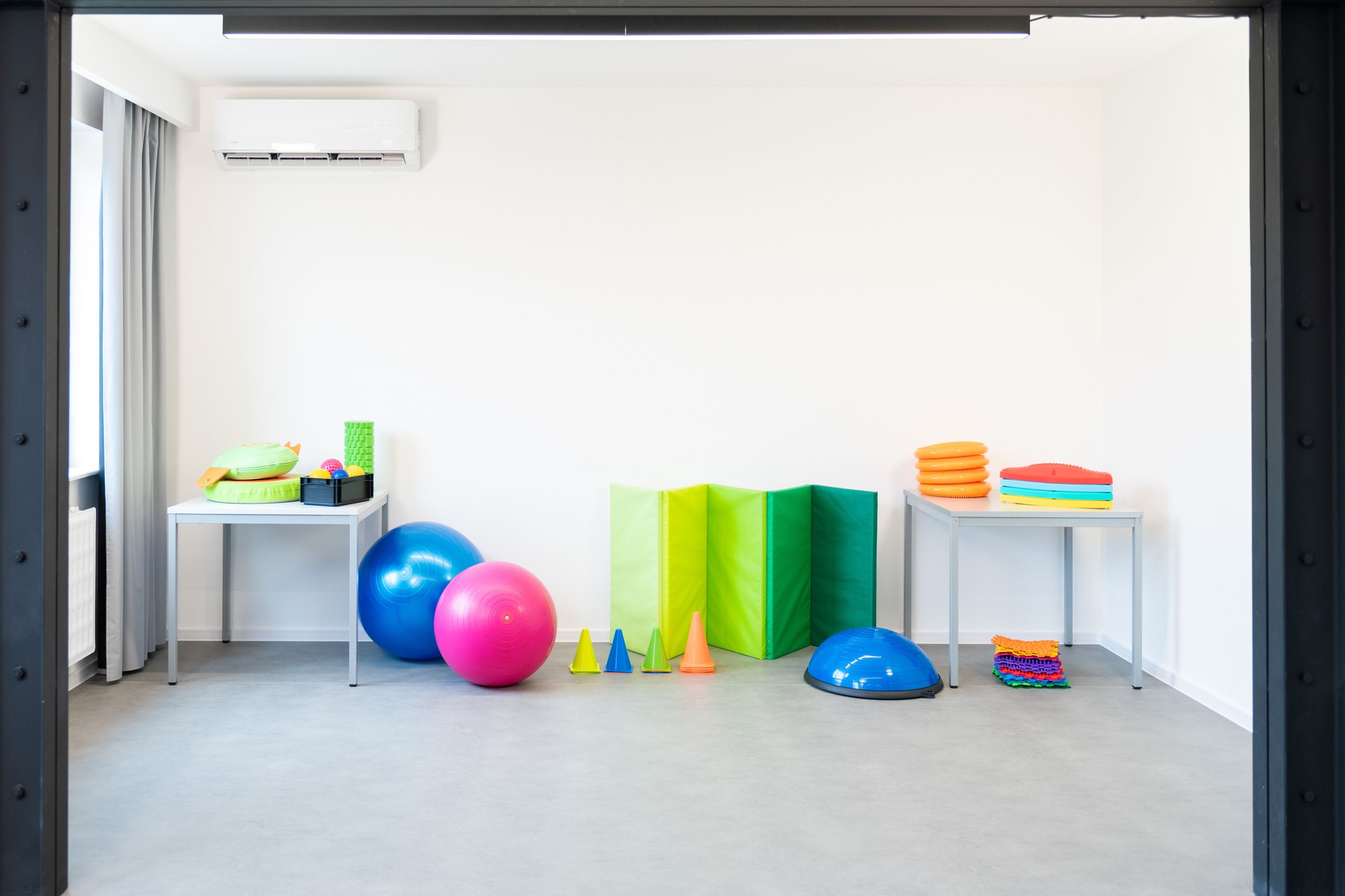 Colorful equipment used in child physical therapy sessions. Physiotherapy room filled with tools.